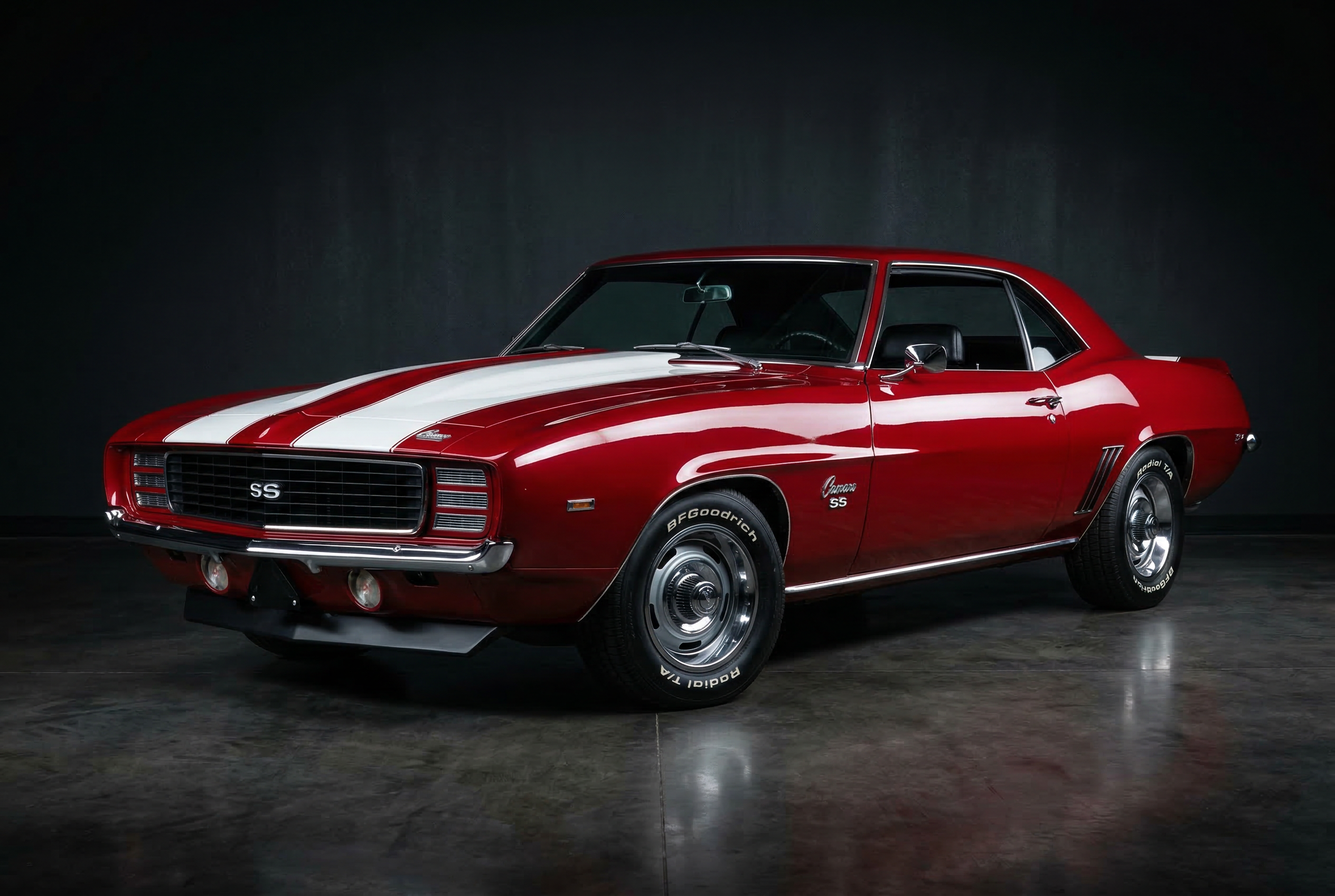 Restored 1969 Chevrolet Camaro SS in cherry red, gleaming in studio lighting